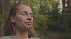 Video of woman exhaling in the woods